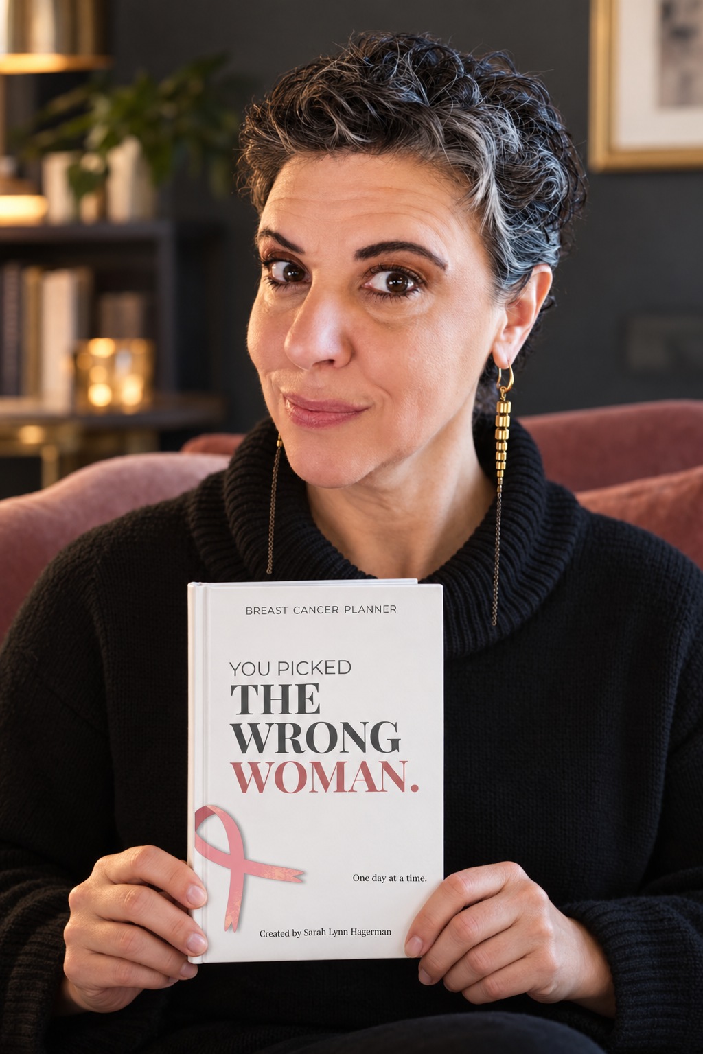 Sarah holding You Picked the Wrong Woman in a styled author portrait